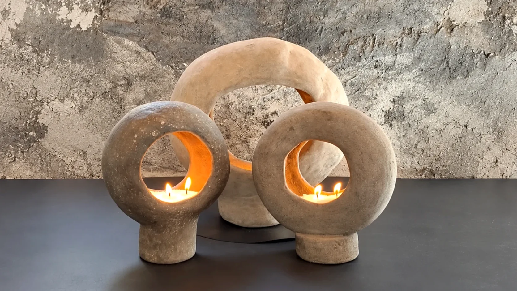 Family of circular concrete pieces in different scales activated with fire